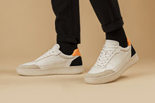 Load image into Gallery viewer,  Person walking with our Hedonist Mandarina Black Vegetable Tanned Leather Sneakers - Side view