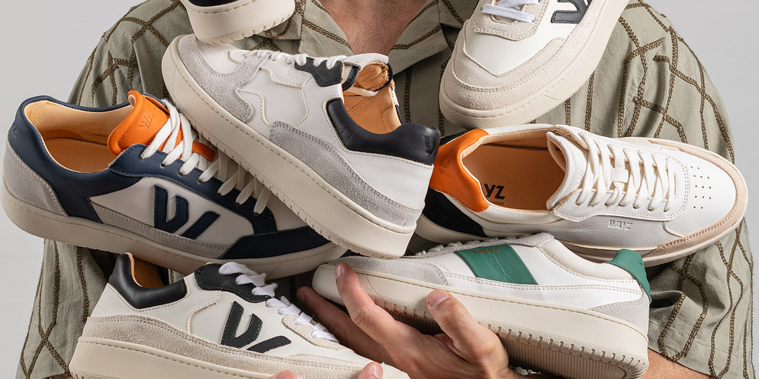 a man wearing a shirt holding the spark white grey green, the hedonist mandarina black, the sonder white grey black, the misfit white grey black and the wanderer white blue orange sneakers