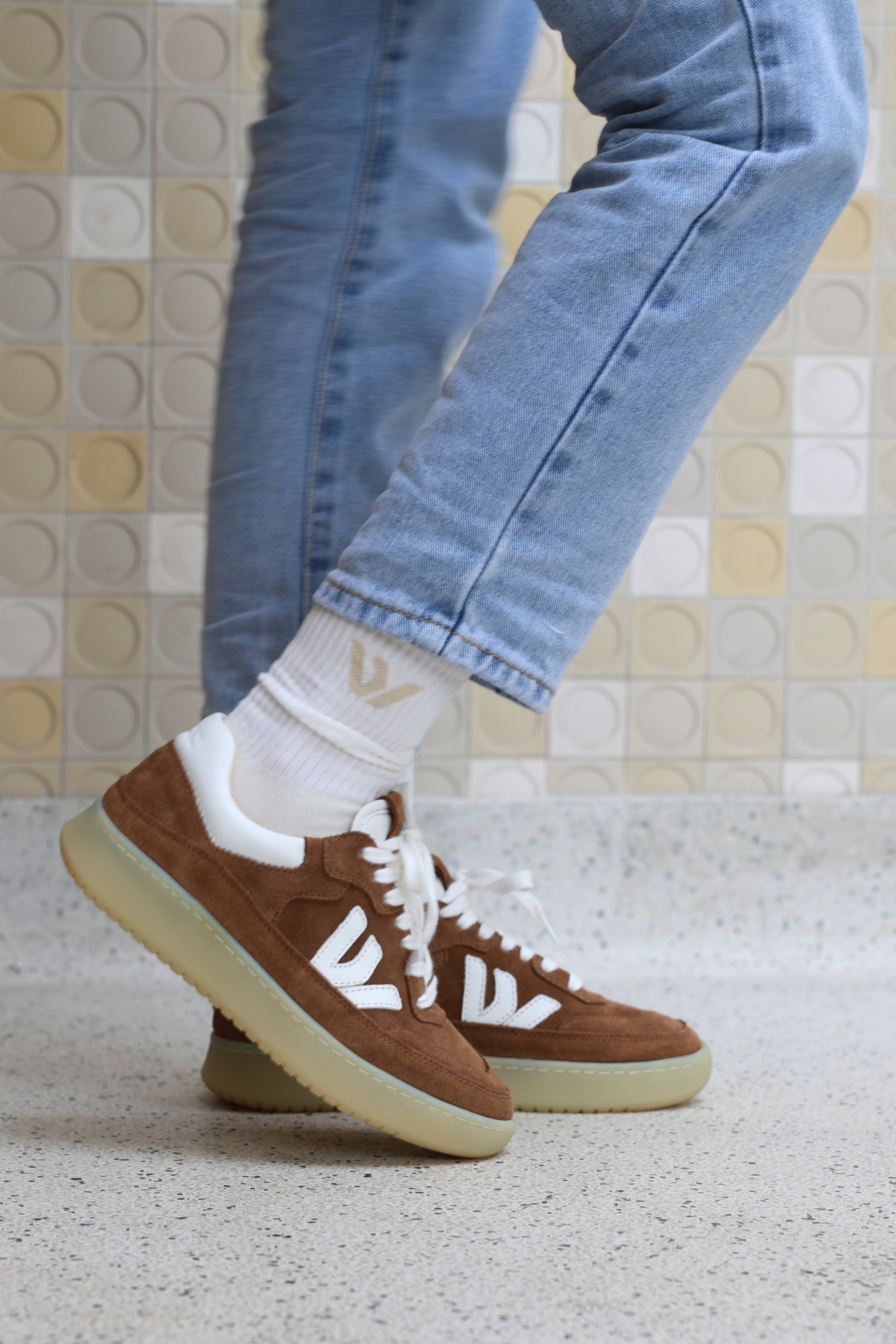 Wayz Misfit White Green Orange sneakers with white soles worn outdoors facing side.