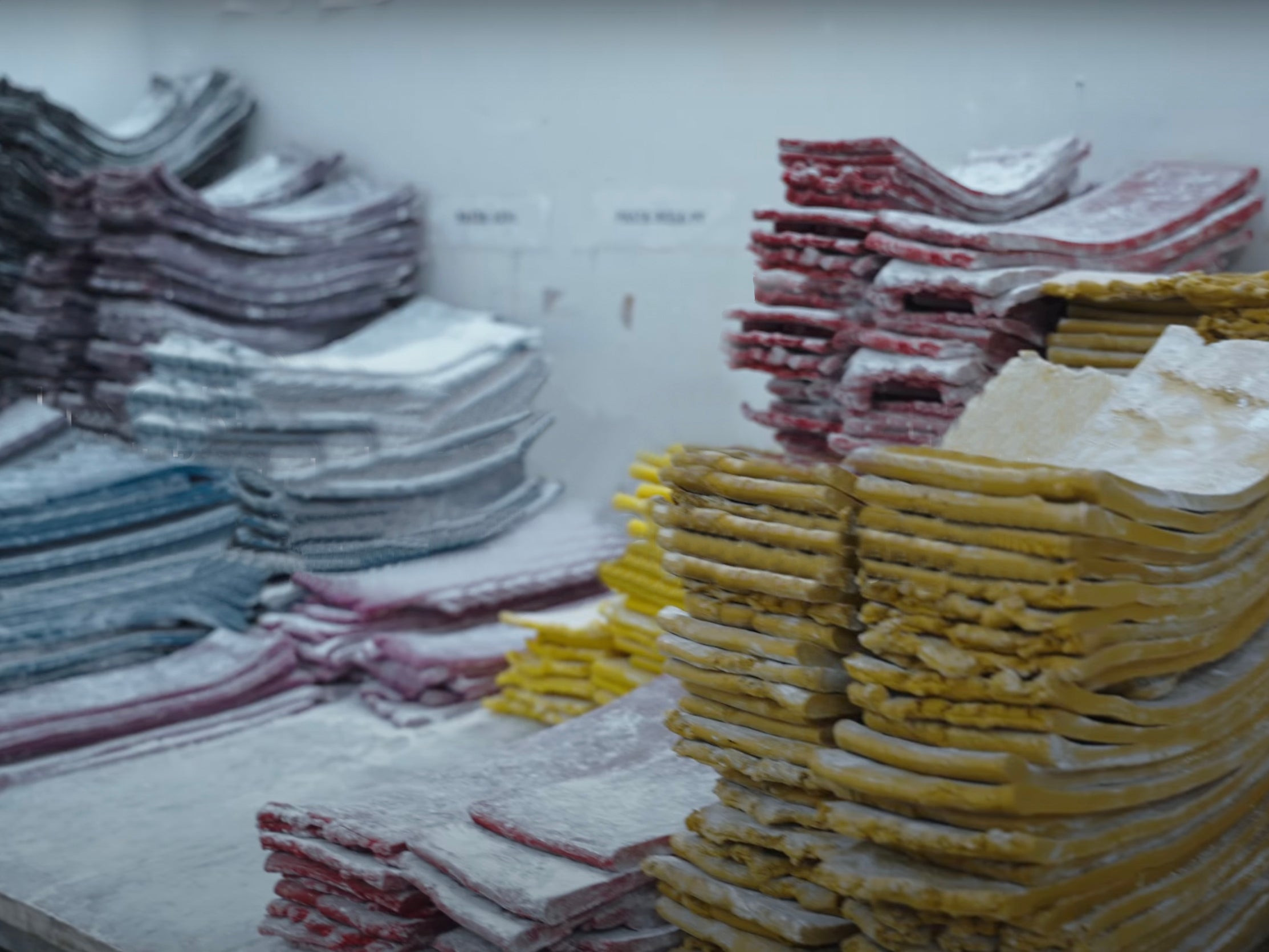 piled up purple, blue, pink, yellow and red sheets of recycled rubber