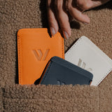 Wayz Card Holder all colours inside a pocket with hands picking it
