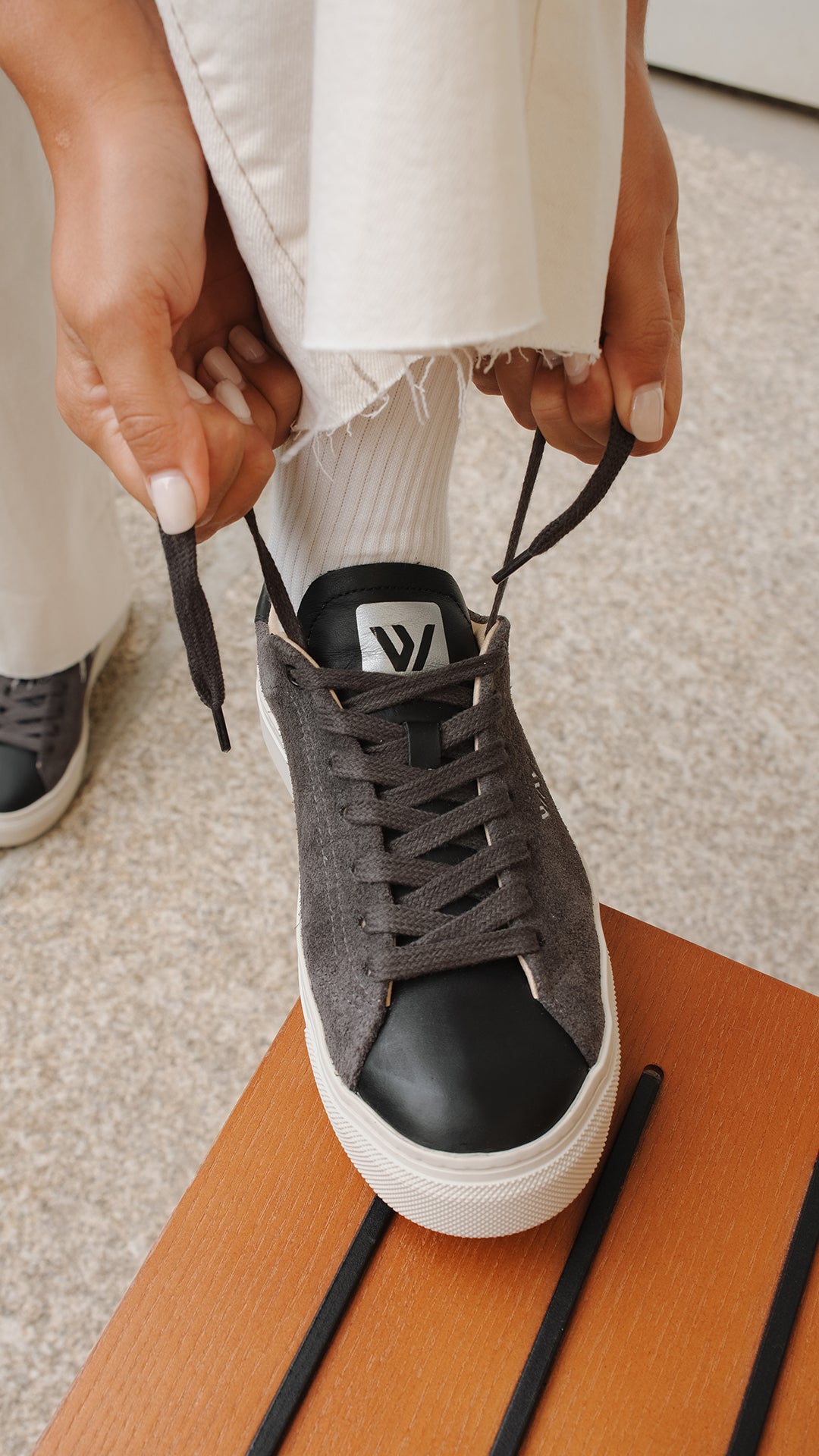 Wayz Grit Anthracite sneakers with white soles worn indoors on chair