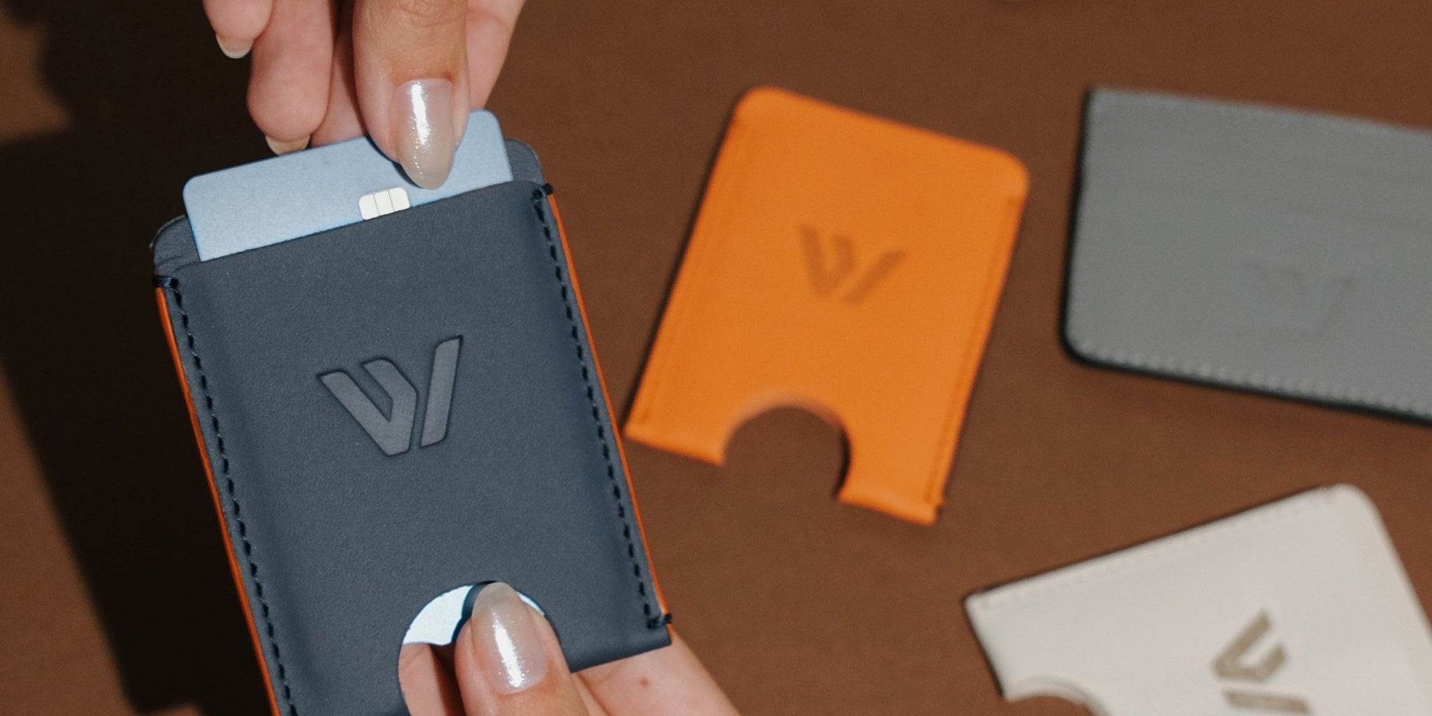 Wayz Card Holder blue jeans wallet with cards being pulled off and other models on the background