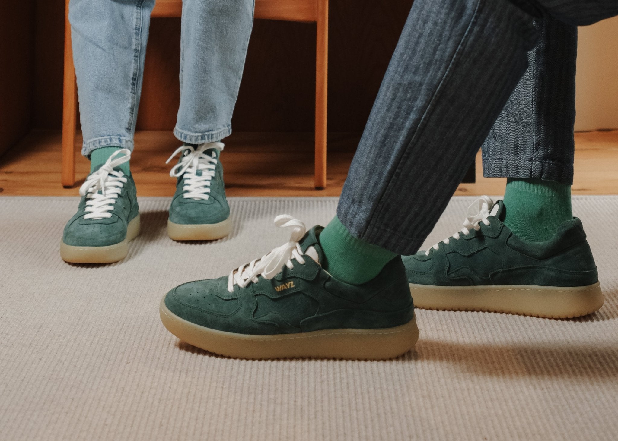 Wayz Sonder Pine Green sneakers facing side and front on top of a carpet