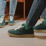 Wayz Sonder Pine Green sneakers facing side and front on top of a carpet