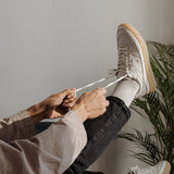 WAYZ Misfit White Gum sneakers being laced.