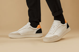  Person walking with our Hedonist Mandarina Black Vegetable Tanned Leather Sneakers - Side view