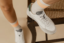 Load image into Gallery viewer, Person wearing our Hedonist White Grey Green Vegetable Tanned Leather Sneakers - Front view