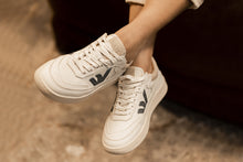 Load image into Gallery viewer, Person wearing our White Grey Almond Milk  Veg-Tan Leather Misfit Sneakers - Front View | Wayz Sneakers
