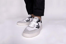 Load image into Gallery viewer, Person wearing our White Grey Black Vegetable Tanned Leather Misfit Sneakers - Front View