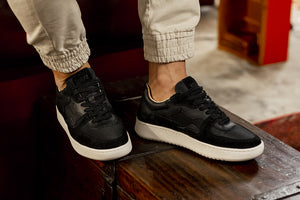 Person wearing our Sonder Triple Black Vegetable Tanned Leather Sneakers - Side view | Wayz Sneakers