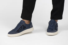 Load image into Gallery viewer, Person wearing Blue Jeans Wanderer Veg-tan Leather Sneakers - Front view | Wayz Sneakers