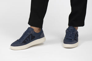 Person wearing Blue Jeans Wanderer Veg-tan Leather Sneakers - Front view | Wayz Sneakers