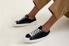 Load image into Gallery viewer, Person wearing The Grit Black Vegan Sneakers - Side view | Wayz Sneakers