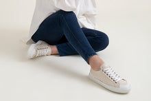 Load image into Gallery viewer, Person wearing The Grit Cream Vegan Sneakers - Side view | Wayz Sneakers
